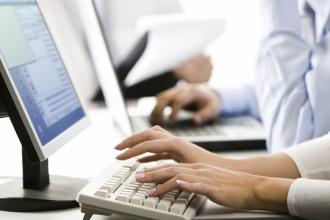 Female employee working at a computer. 