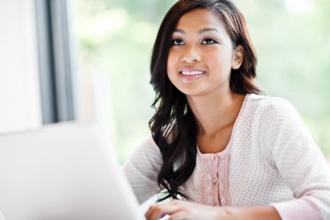 A female student using a laptop.