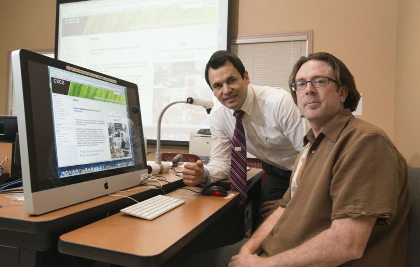 Drs. Brian Foley and John Reveles pose in a computer lab