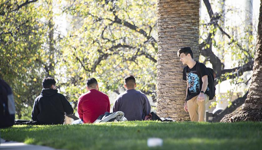 A group of students sitting in front of Oviatt Library