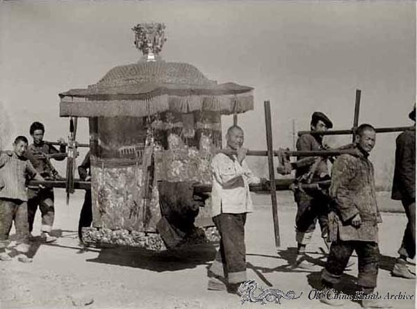 Palanquin with bride being carried to wedding on country road leading to Tienstin, spring 1946