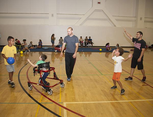 Several of the children enrolled in the Sensory Motor Program play a game called, “keep out of reach” with some assistance from CSUN students. The children pictured from left to right are: Dean Genderlink, Nicolas Noblitt and Carter Genderlink. Photo by V