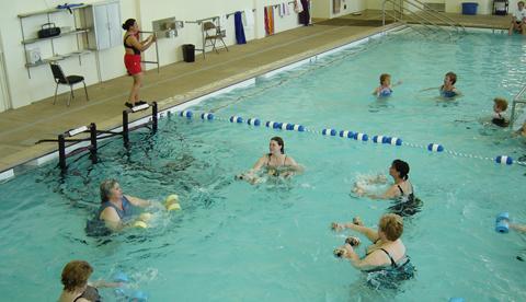 Clients and trainers practice fitness in the main pool