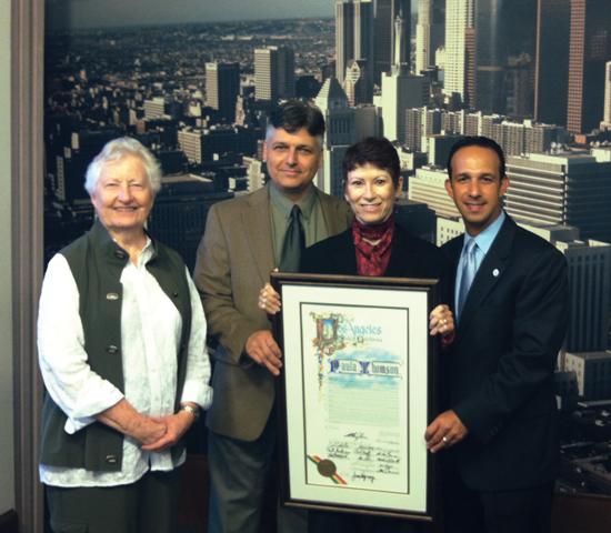 CSUN kinesiology professor Paula Thomson accepts resolution from Los Angeles City Councilman Mitchell Englander. From left: Carole Oglesby, former chair of the Department of Kinesiology; Thomson’s husband, Maurice Godin; Thomson and Councilman Englander.