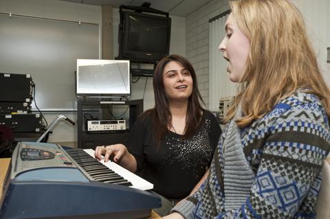 voice coach works with student in the communication disorders and sciences voice lab