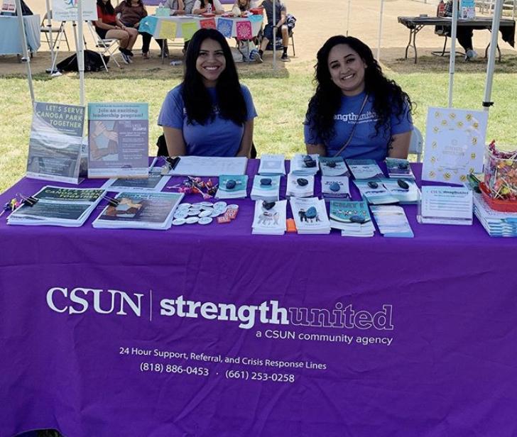 StrengthUnited members at a display table