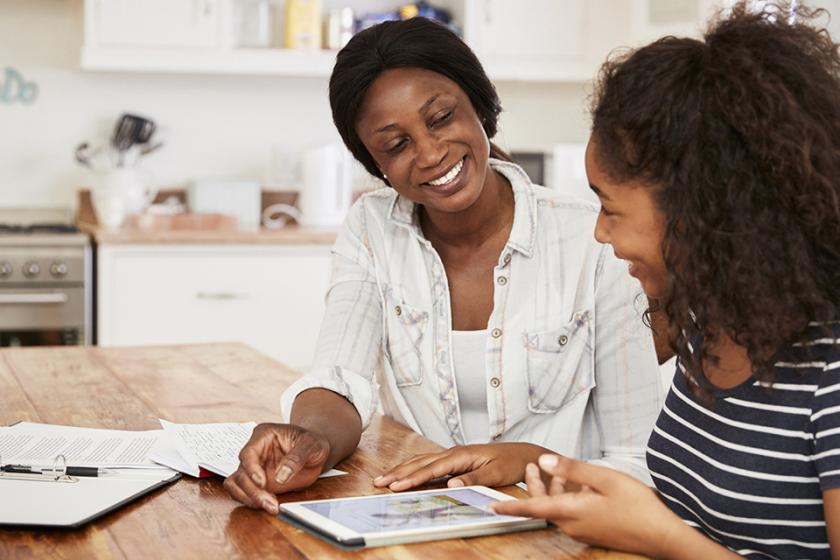 A mother helps teenage daughter with homework using digital tablet. Photo by monkeybusinessimages, iStock.