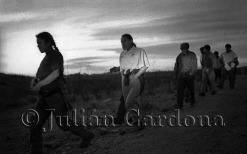 At sundown, hundreds of migrants march north in groups of twenty, hoping to cross the border. Each group is joined by a smuggler, whose identity is not revealed and who acts as a guide. Agua Prieta, Sonora. May 2000.