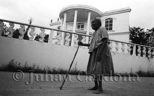 Felicitas Ruiz Ramos, 88, stands in front of the houuse built by her son Gerardo Perez Ruiz, who lives in the United States. San Andres Ixtlahuaca, Oaxaca. November 2006.