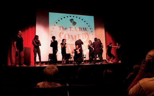 10 Students of Teenage Drama Workshop in action on stage for the comedy improv night