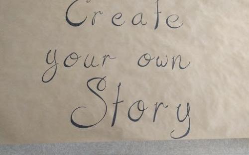 Brown poster paper with the words, “create your own story”