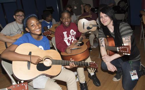 Emord performs with students during NAMM&#039;s Day Of Service in Washington D.C. Photo by Kris Connor/Getty Images for NAMM.