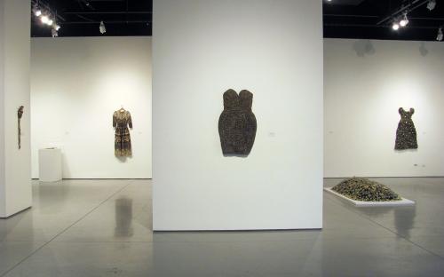 Installation view of button dress, cocktail dress, and artist as Ophelia. 