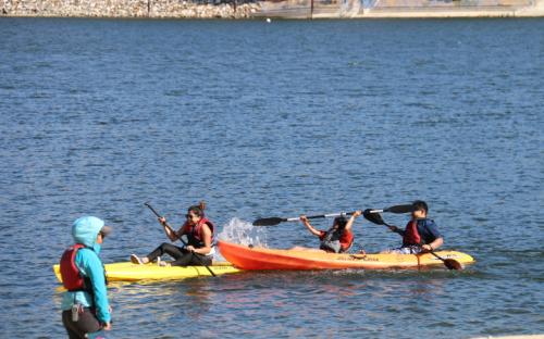 Scholars and Staff Member kayaking.