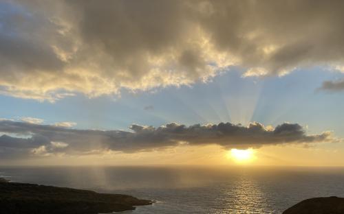 Ocean sunrise with a cloud of rain approaching – Hawaii 