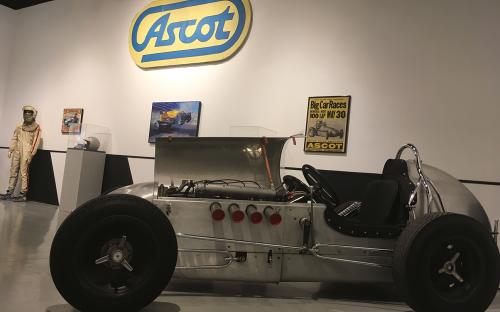 install image of midget car with buffed out finish.  Ascot sign and original posters in the background. 