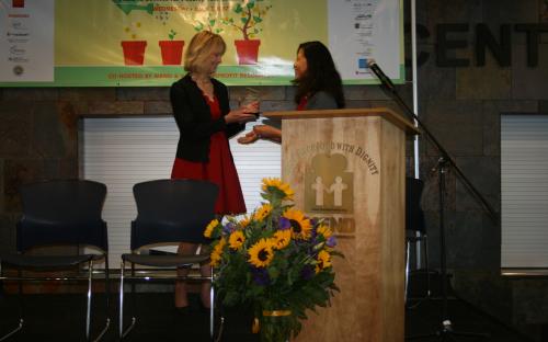 MEND Board Chair Jocelyn Guihama presents award to former MEND CEO Marianne Haver Hill