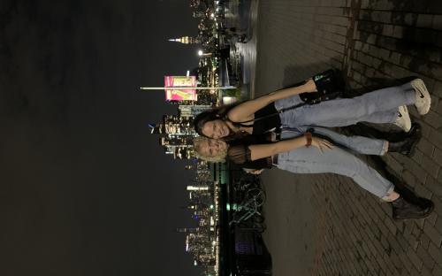 Friends in front of the New York City skyline at night – New York City, New York