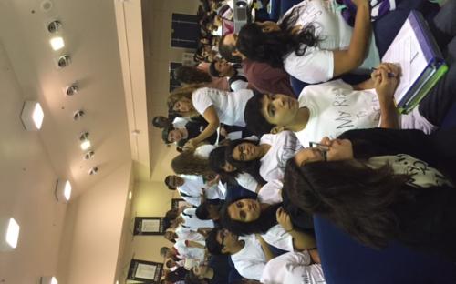 Students gather and chatter during an assembly.