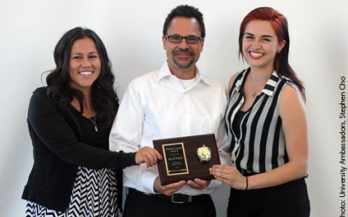 Child and Adolescent Development Faculty and Chair David Wakefield receives the Polished Apple Award from Catherine Placencia and Christine Matos.