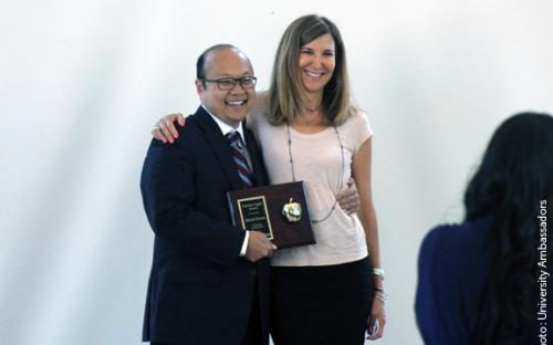 Stephen Cho presents the Polished Apple Award to Health Sciences faculty, Deborah Forman.