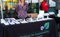 Woman standing behind Institute for Sustainability table