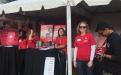 Fundraising tents at the CSUN Grand Reunion, with individuals trying to solicit donations from alumni.