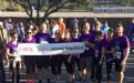 Strength United team members show off their banner on race day.