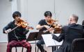 Violinists Kazeoki Katagiri and Joshua Rim perform in Bin Huang&#039;s master class at CSUN&#039;s ChamberFest. Photo by David J. Hawkins.