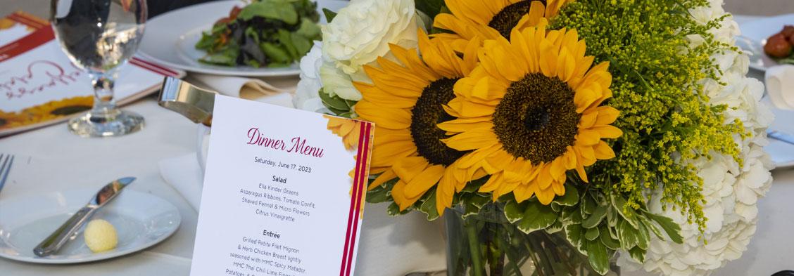 Picture of MMC Event Menus and Sunflower on Table