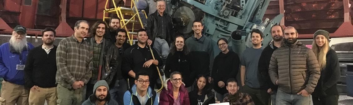 Science education students in front a large telescope