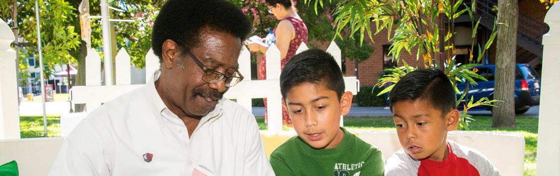 Dr. Watkins reading to children.