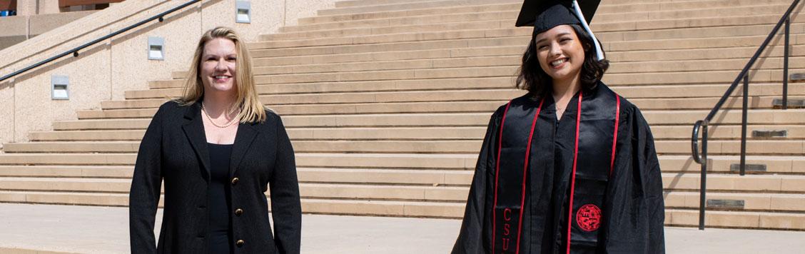 President Beck and female student in commencement robes.
