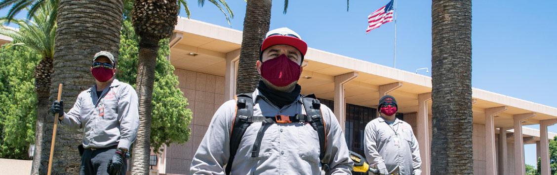 Masked Physical Plant workers on campus.