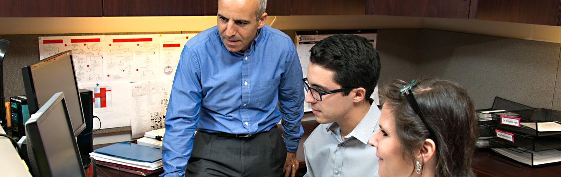 Dr. Efrat and students at computer.