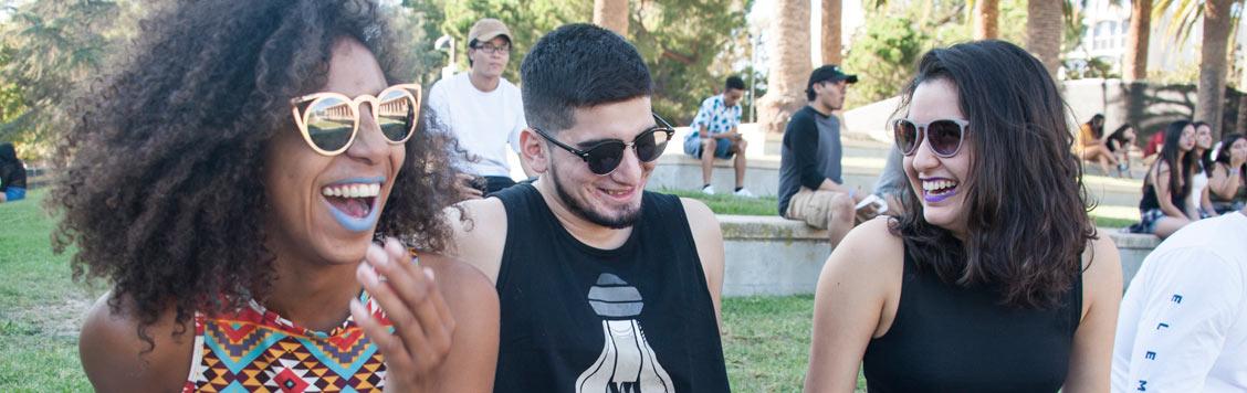 Students sharing a laugh in front of the library.