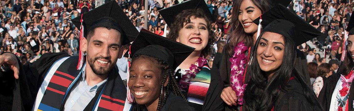 Happy diverse students celebrating at Commencement.