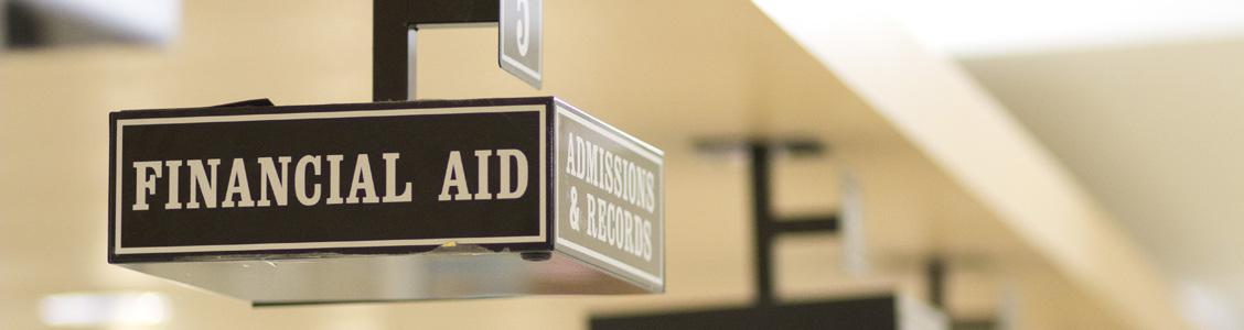 Sign hanging from ceiling that says Financial Aid