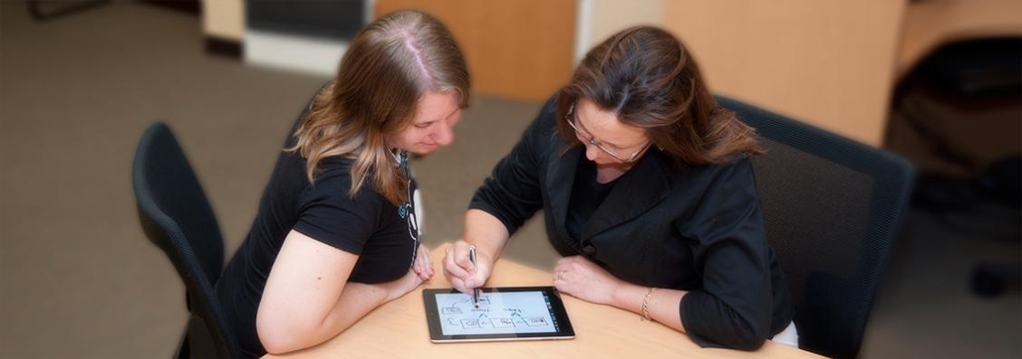 Student and faculty using an iPad