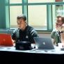 Men work behind their laptop computers
