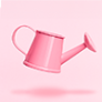 pink watering can against a pink background