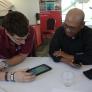 Two men look at tablet at CSUN Technology Fair.