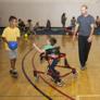 kinesiology graduate student coaches children in motor skills activity
