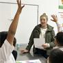 students raise their hands in nutrition education class