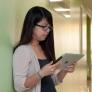 Student uses iPad in hallway