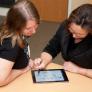 Student and faculty work on an iPad.