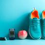 Sneakers, apple, and jump rope against a wall