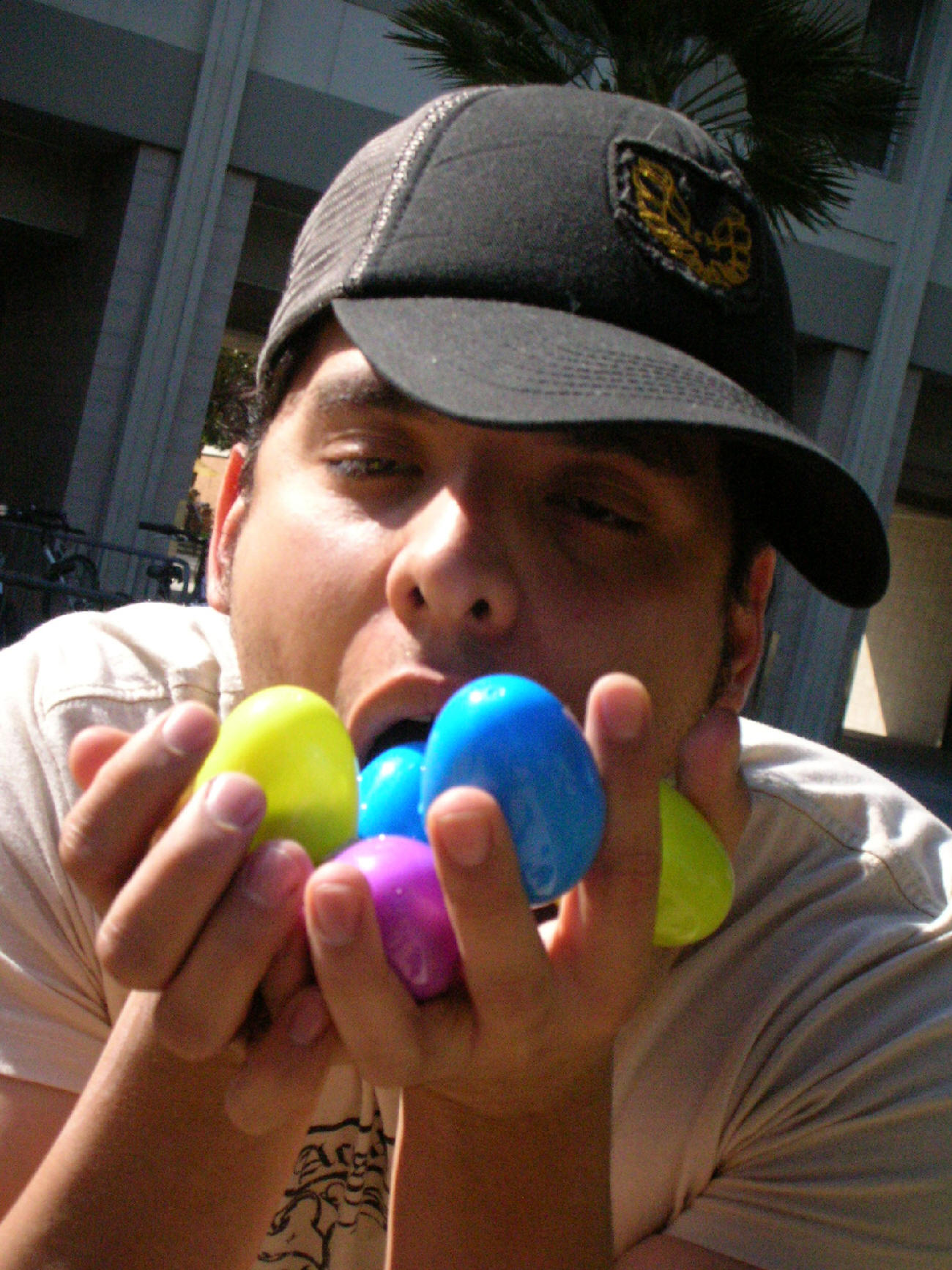 Jesse, holding multicolor plastic eggs under his chin with a very excited look on his face.
