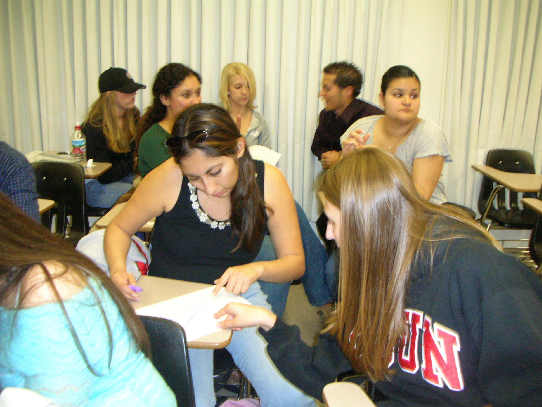 A Fellow classmate asking her group mate whether or not she has found all the correct words.
