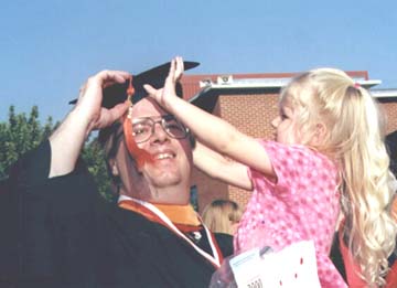 Young Daughter and Graduating Dad